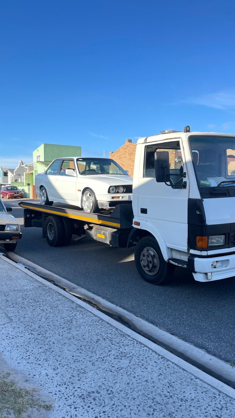BMW loaded on flatbed tow truck